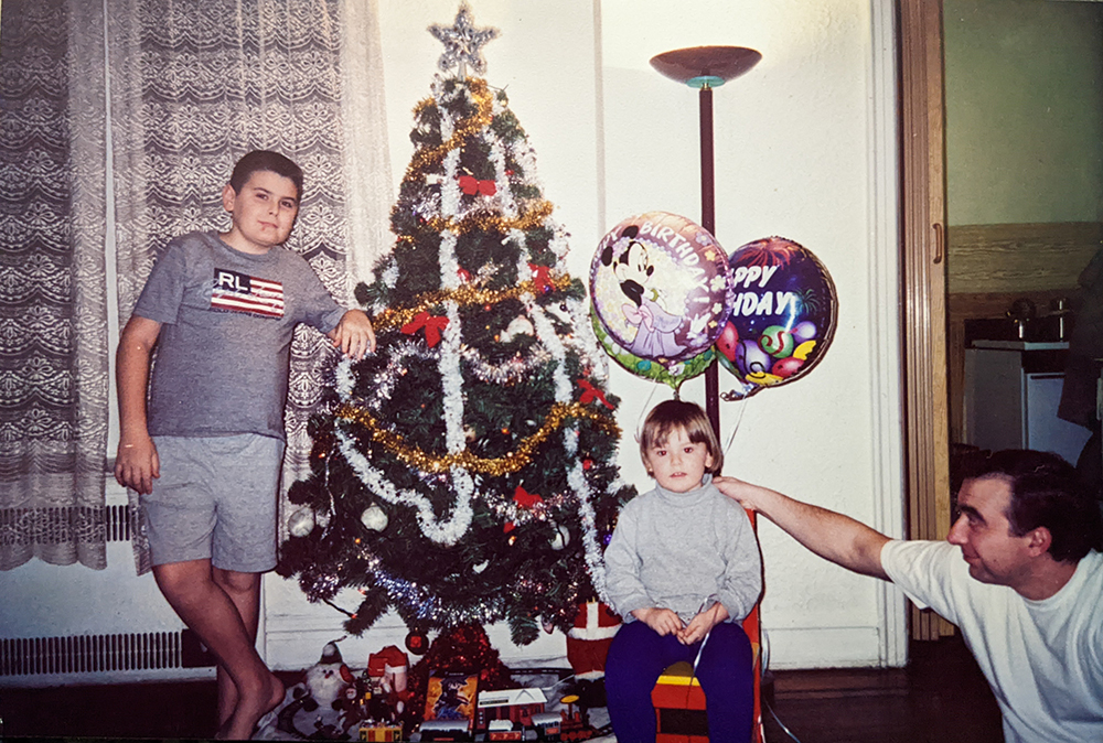 Three people with Christmas tree.