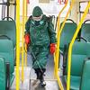 Suited man disinfects bus
