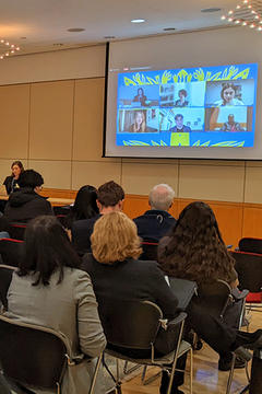 Virtual Panel 2 on screen with audience seated in front