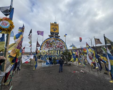 Donetsk sign surrounded by Ukrainian flags. Photo by David Kirichenko