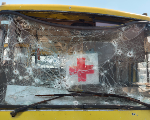 An ambulance with its windshield shattered