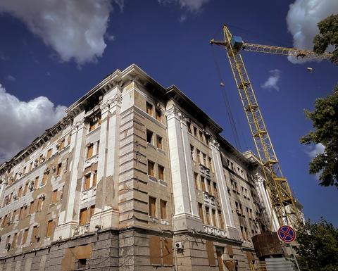 Damaged building in Kharkiv with crane