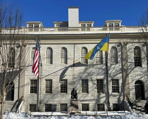 The Ukrainian and American flags on the front facade of Harvard's University Hall
