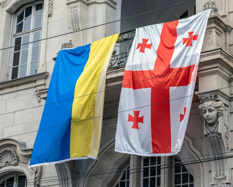 Ukrainian and Georgian flags hung side by side on a Georgian street.